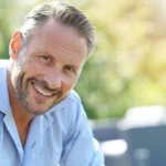 smiling mature man relaxing outside