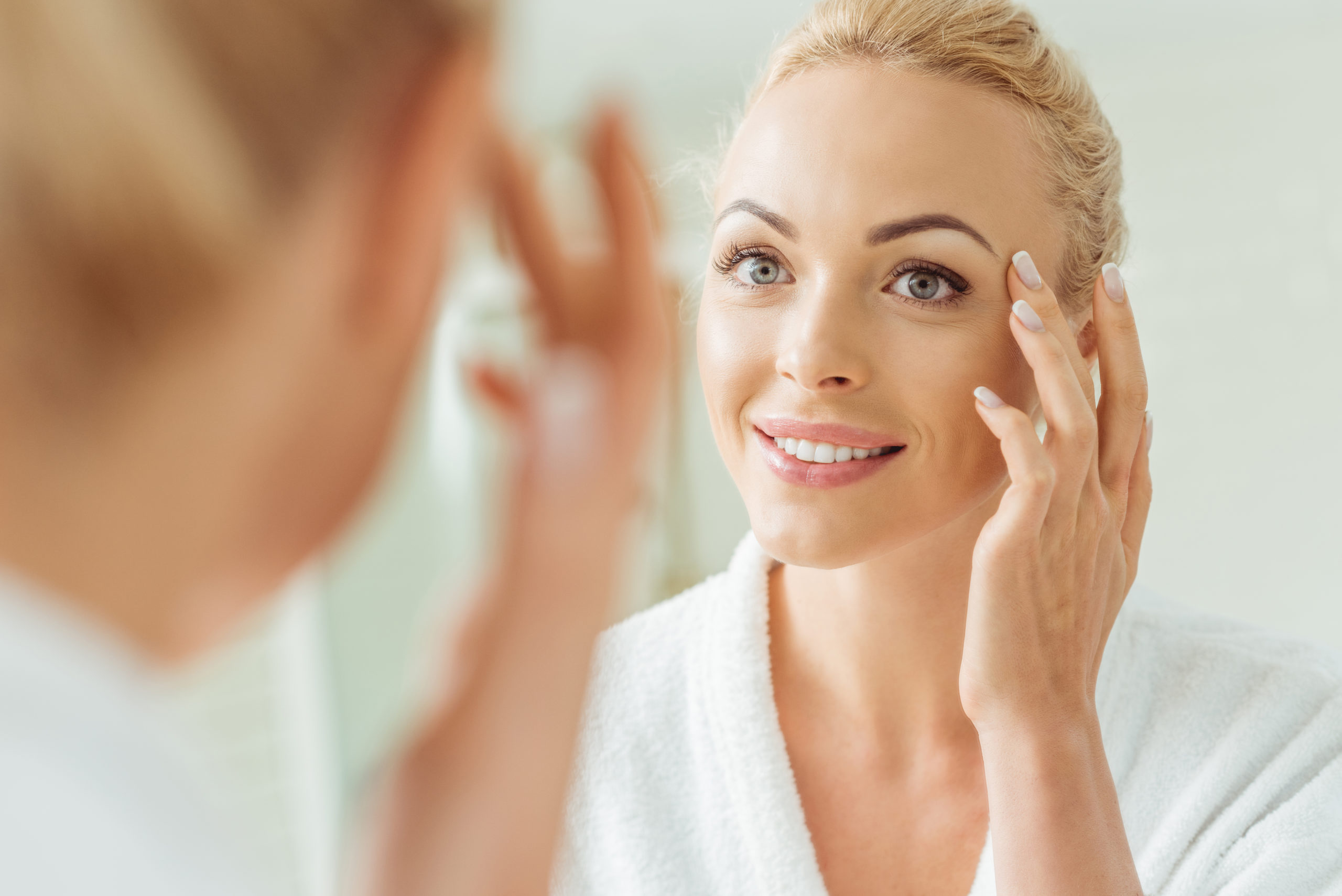 beautiful woman looking at mirror - Brow Lift